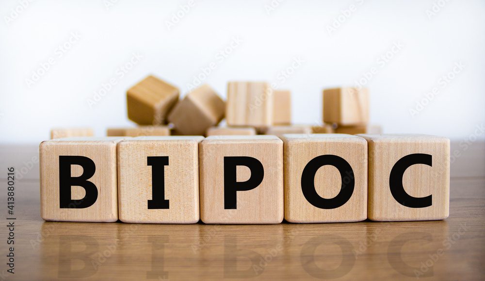 BIPOC symbol. Abbreviation BIPOC, black, indigenous and people of color on wooden cubes. Beautiful white background. Copy space. Business and BIPOC, black, indigenous and people of color concept.