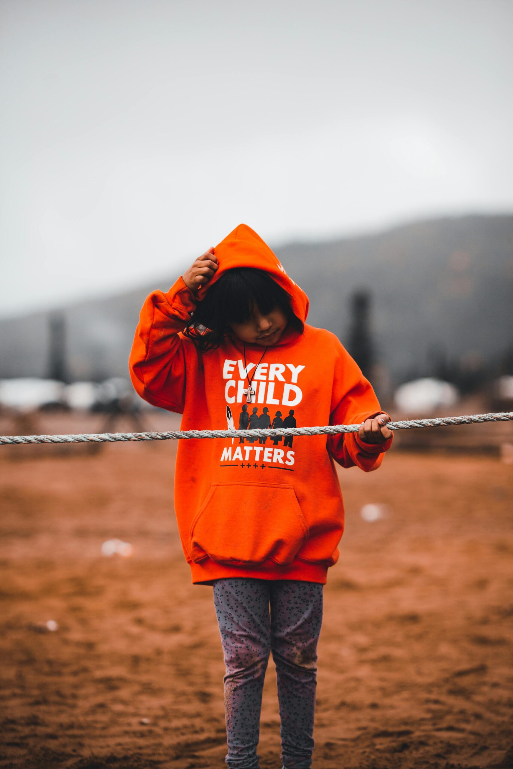 Girl in Hoodie Touching Rope